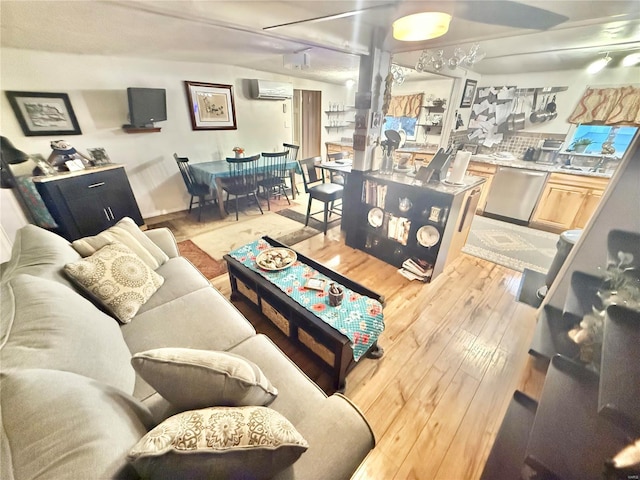 living room featuring light hardwood / wood-style floors and an AC wall unit