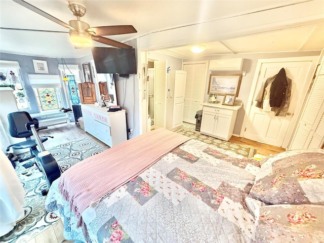 bedroom with light hardwood / wood-style flooring and an AC wall unit