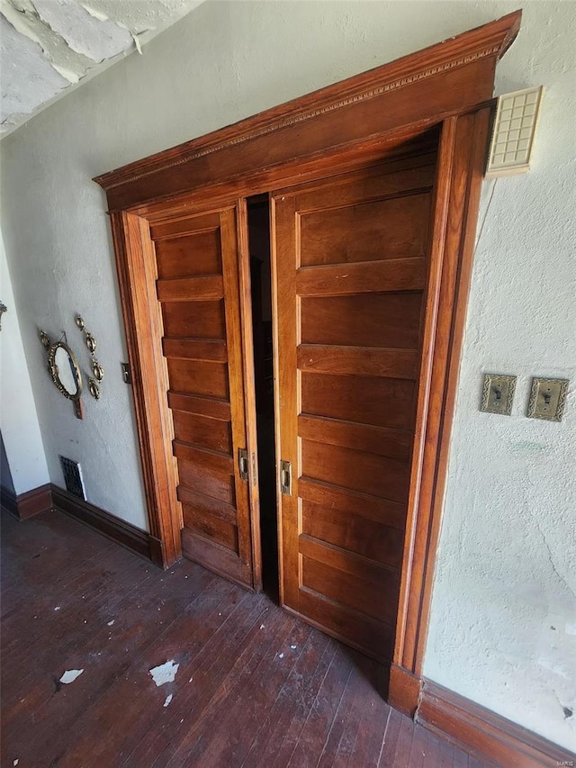 corridor with dark hardwood / wood-style flooring