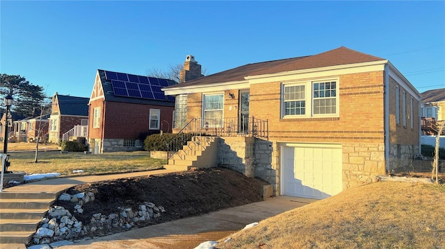 view of front facade featuring a garage and solar panels