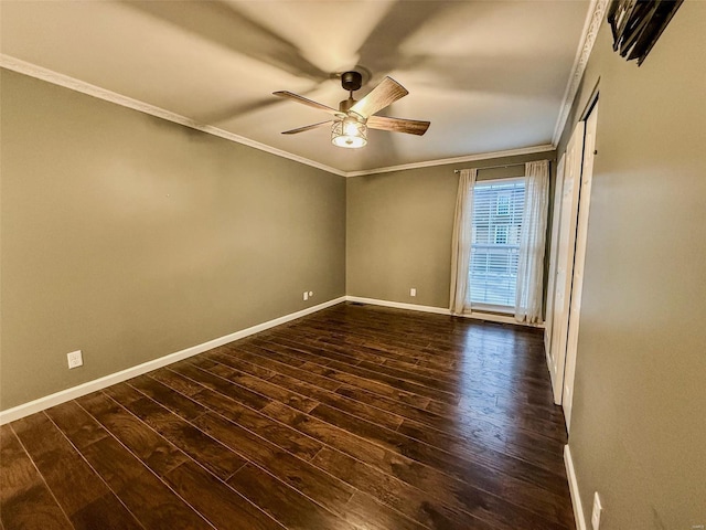 unfurnished room with ceiling fan, dark wood-type flooring, baseboards, and crown molding