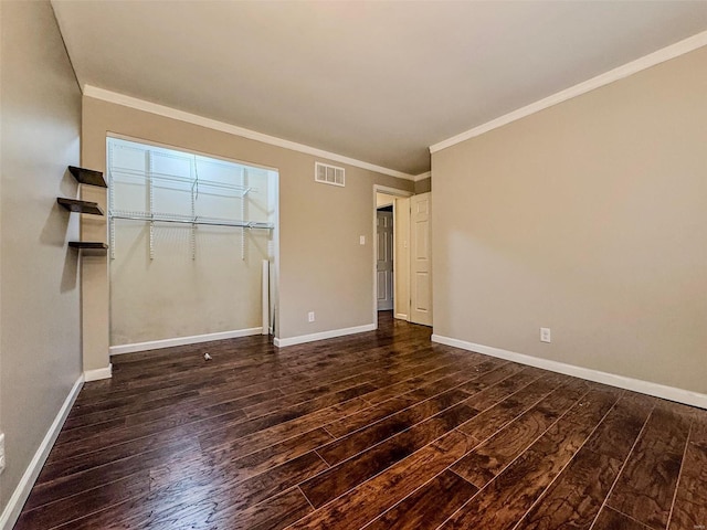 unfurnished bedroom with baseboards, visible vents, wood finished floors, and ornamental molding