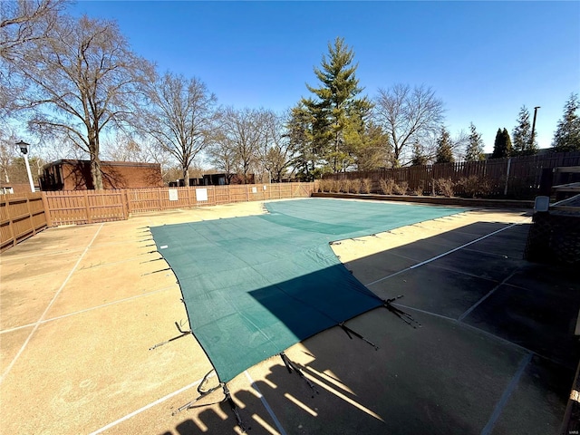 pool with a patio and a fenced backyard