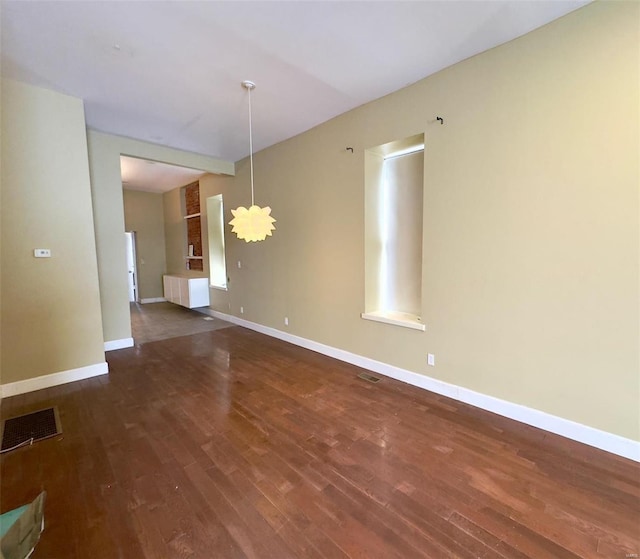 spare room with dark hardwood / wood-style flooring