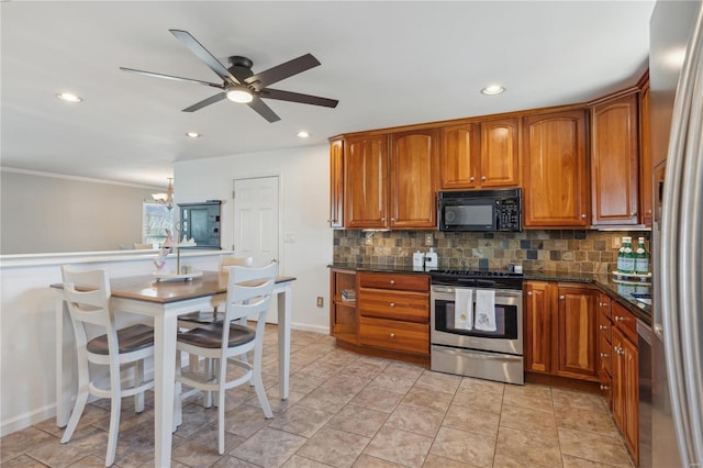 kitchen with recessed lighting, ceiling fan with notable chandelier, stainless steel appliances, backsplash, and brown cabinetry