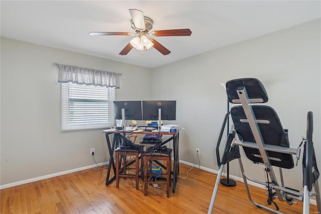 office with a ceiling fan, baseboards, and wood finished floors