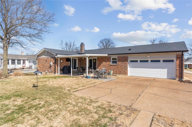 ranch-style home featuring brick siding, concrete driveway, a chimney, an attached garage, and a front yard