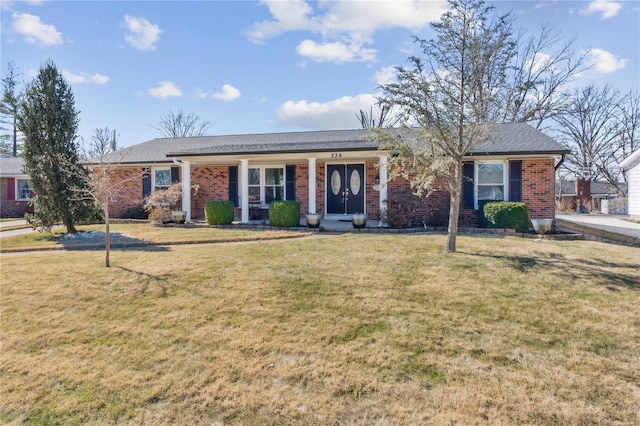 single story home featuring a front yard and brick siding