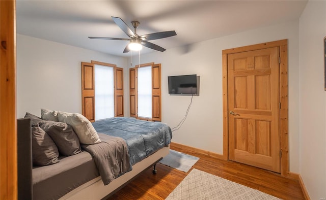 bedroom with hardwood / wood-style floors and ceiling fan