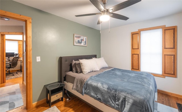 bedroom with wood-type flooring and ceiling fan