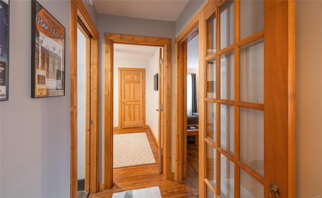 hall featuring french doors and wood-type flooring