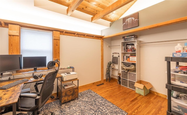 office space featuring hardwood / wood-style flooring, wooden ceiling, and vaulted ceiling with beams