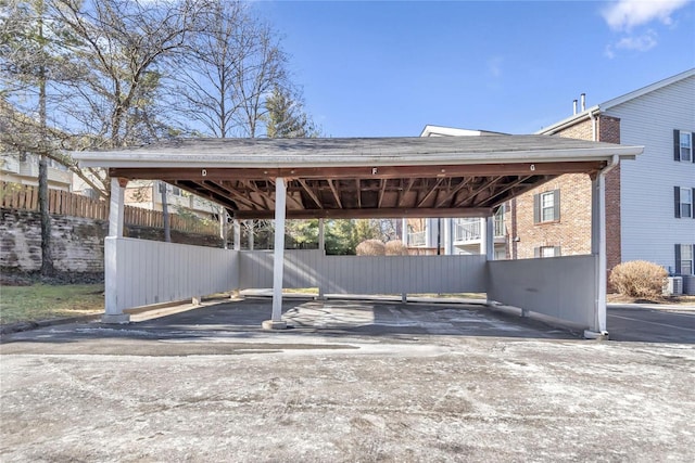 view of vehicle parking featuring fence