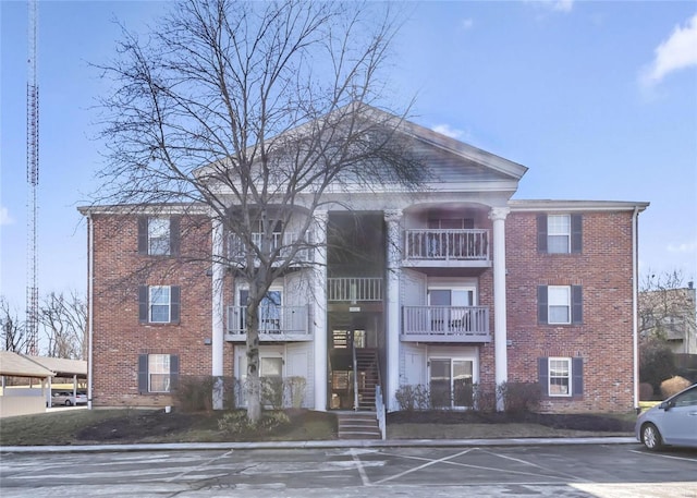 view of building exterior featuring uncovered parking