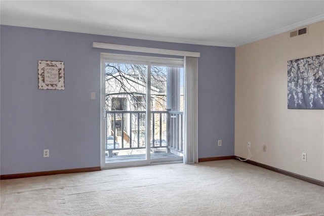 carpeted empty room with ornamental molding, visible vents, and baseboards