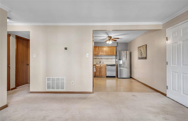 kitchen with visible vents, light colored carpet, appliances with stainless steel finishes, light countertops, and a sink