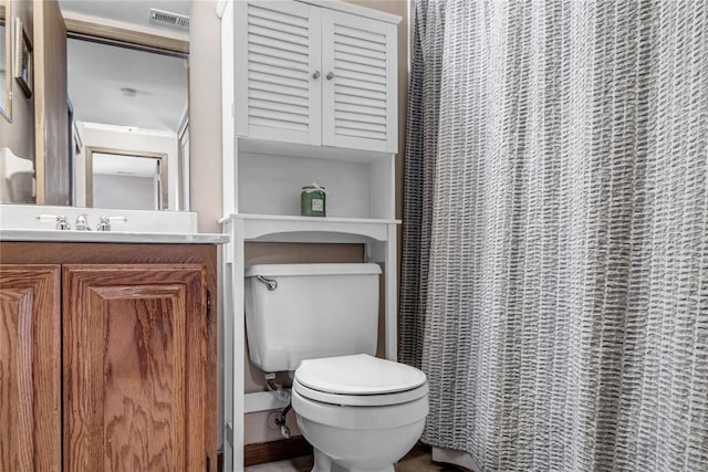 full bathroom featuring toilet, visible vents, and vanity