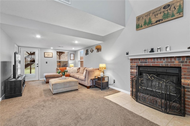 living room with a brick fireplace and light colored carpet