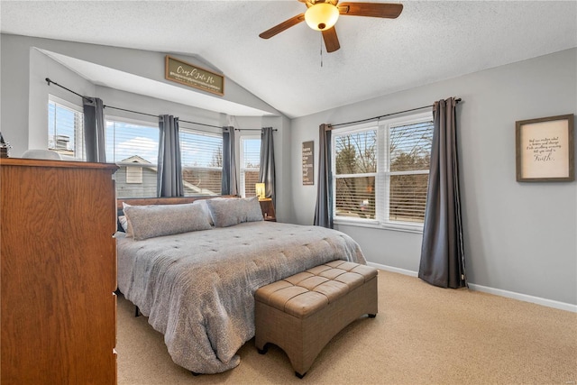 carpeted bedroom with ceiling fan, lofted ceiling, and a textured ceiling