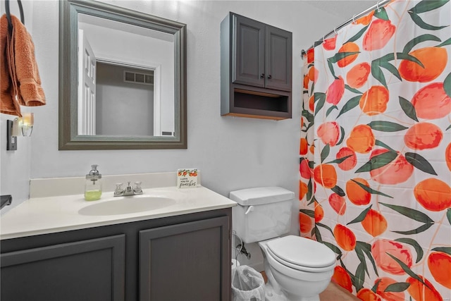 bathroom featuring vanity, curtained shower, and toilet