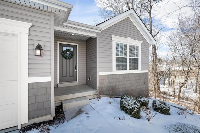 view of snow covered property entrance