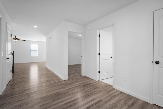 empty room featuring wood-type flooring and ceiling fan