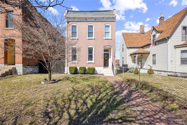 italianate-style house with entry steps, a front yard, and fence