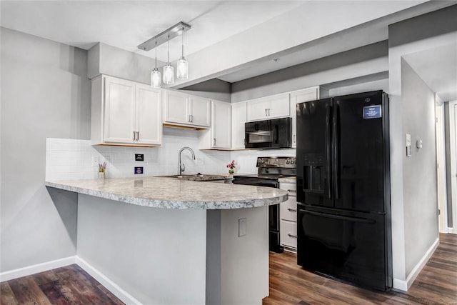 kitchen featuring dark hardwood / wood-style floors, decorative light fixtures, white cabinets, decorative backsplash, and black appliances