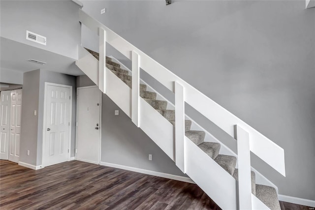 staircase with hardwood / wood-style flooring