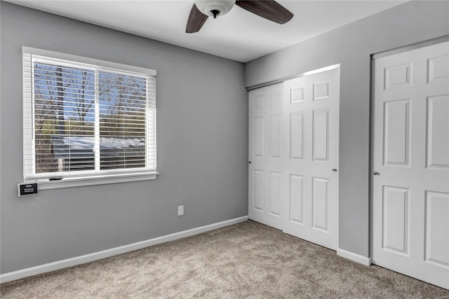 unfurnished bedroom featuring light colored carpet, a closet, and ceiling fan