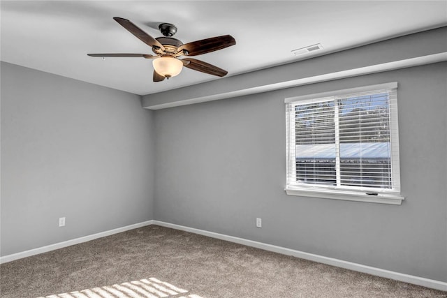 empty room featuring carpet flooring and ceiling fan