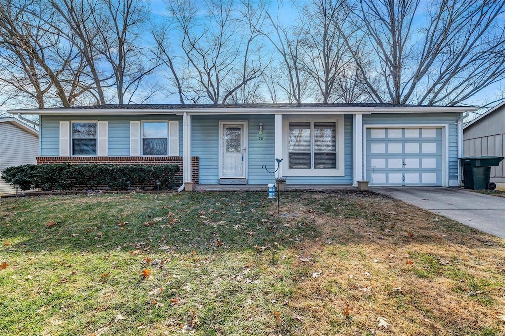 single story home with a garage and a front lawn