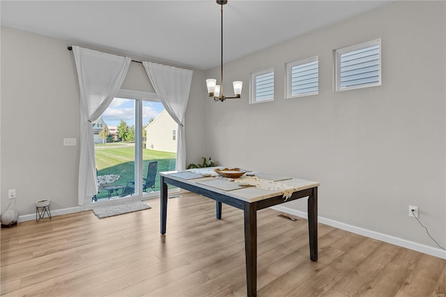 dining room with a notable chandelier and light hardwood / wood-style flooring