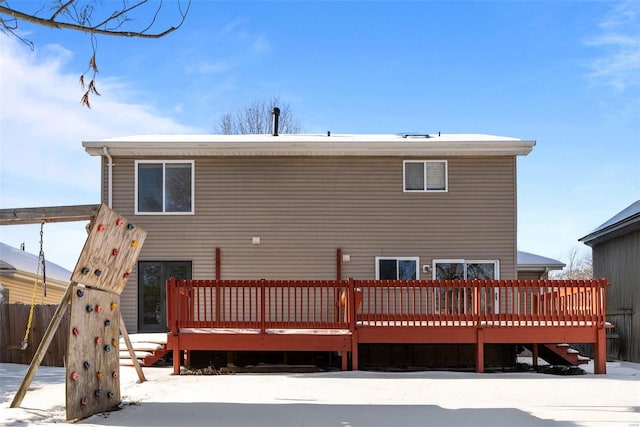 snow covered property featuring a wooden deck