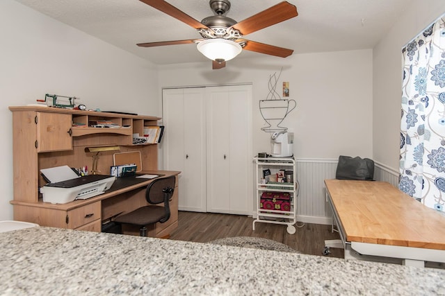 office area with ceiling fan, dark hardwood / wood-style flooring, and a textured ceiling