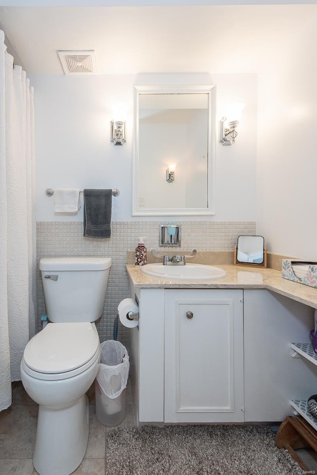 bathroom featuring tile patterned floors, vanity, and toilet