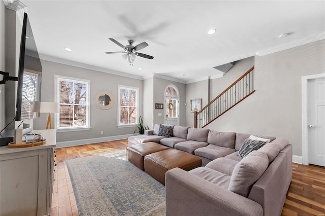 living room featuring crown molding, a healthy amount of sunlight, and wood-type flooring