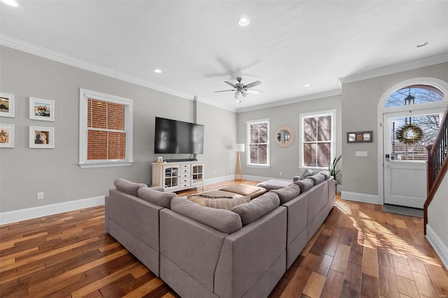 living room with ornamental molding, plenty of natural light, and dark hardwood / wood-style flooring