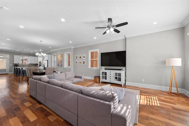 living room featuring wood-type flooring, ornamental molding, and a healthy amount of sunlight