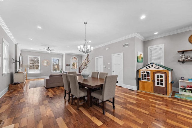 dining space featuring crown molding, ceiling fan with notable chandelier, and hardwood / wood-style floors