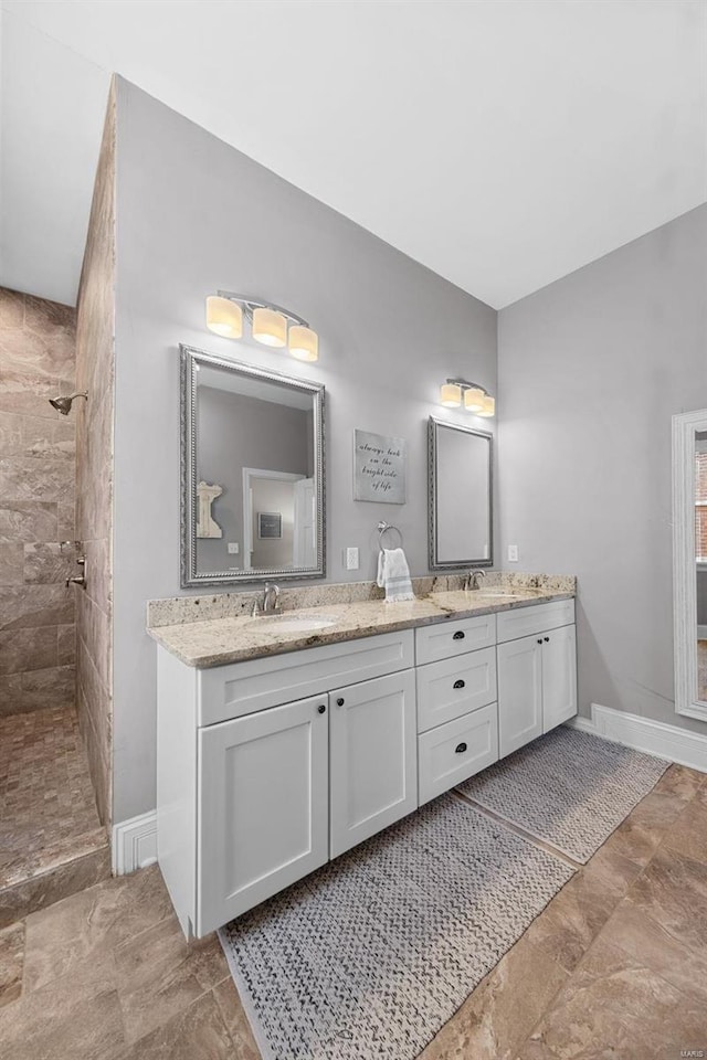 bathroom featuring vanity and tiled shower