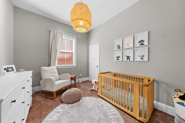 bedroom featuring a nursery area and carpet