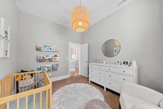 carpeted bedroom with a crib