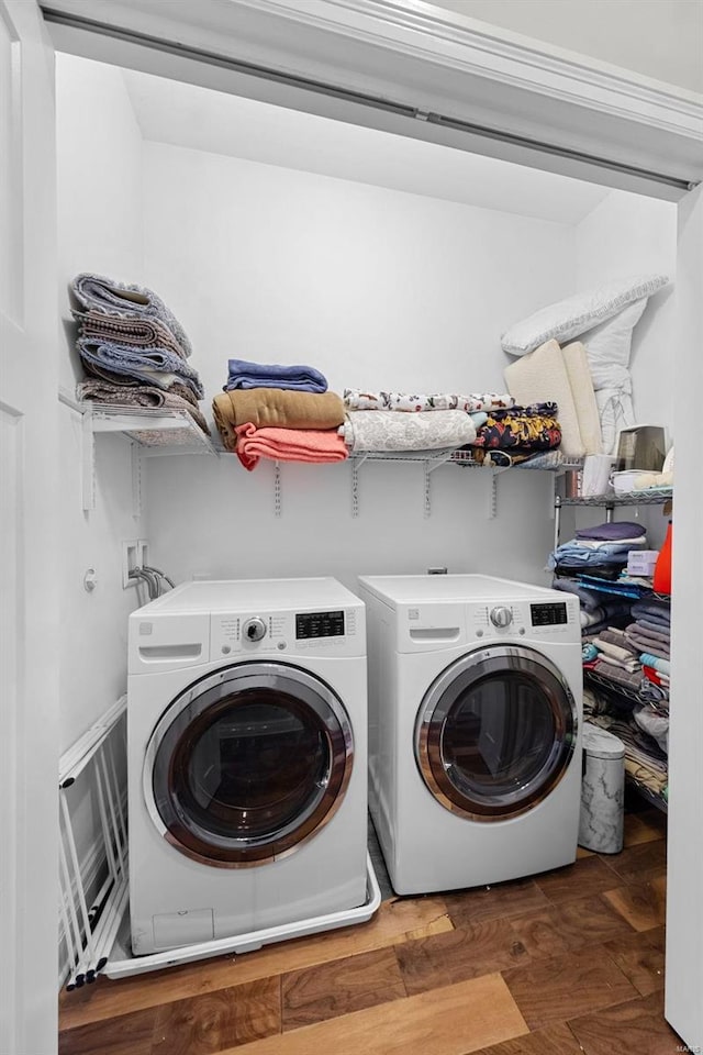 laundry room with dark hardwood / wood-style floors and washing machine and dryer