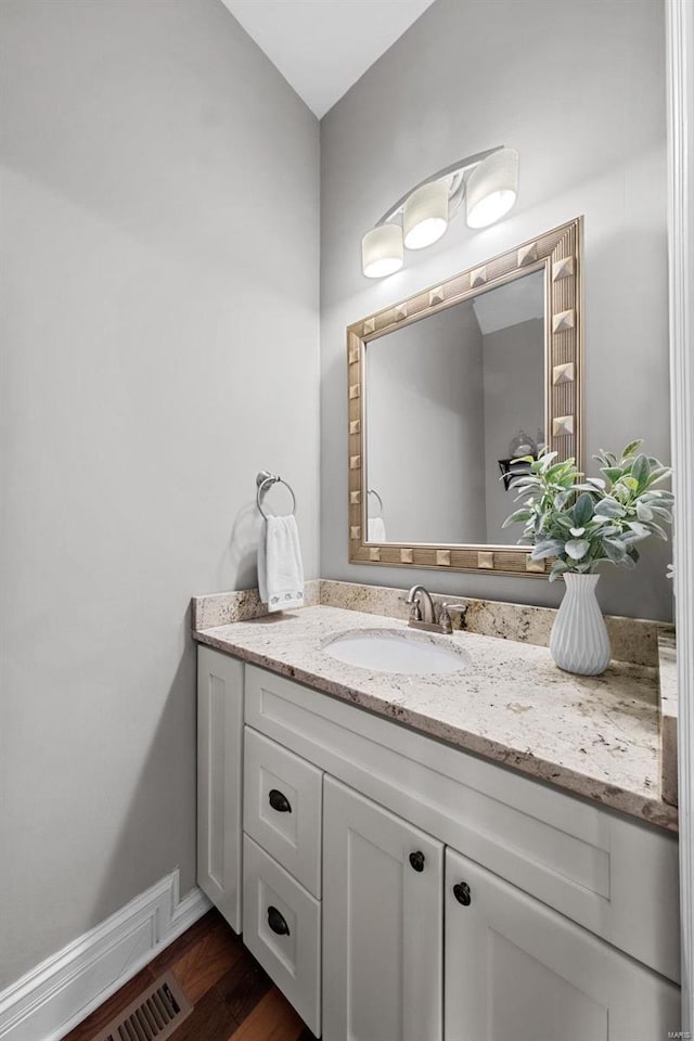 bathroom with vanity and hardwood / wood-style floors