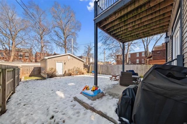 snowy yard with a storage unit