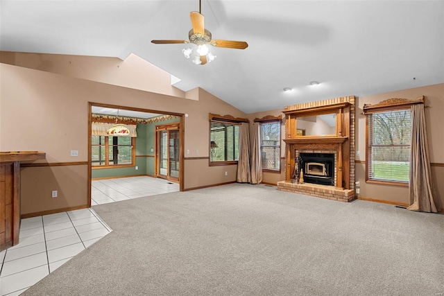 unfurnished living room with vaulted ceiling, a brick fireplace, light carpet, and ceiling fan