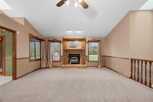 unfurnished living room with ceiling fan, lofted ceiling, and light carpet