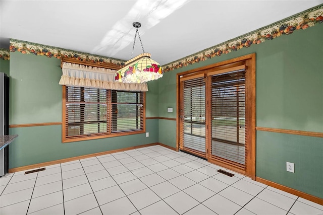 unfurnished dining area with tile patterned floors