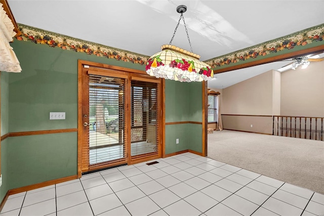 unfurnished dining area with lofted ceiling, carpet flooring, and ceiling fan